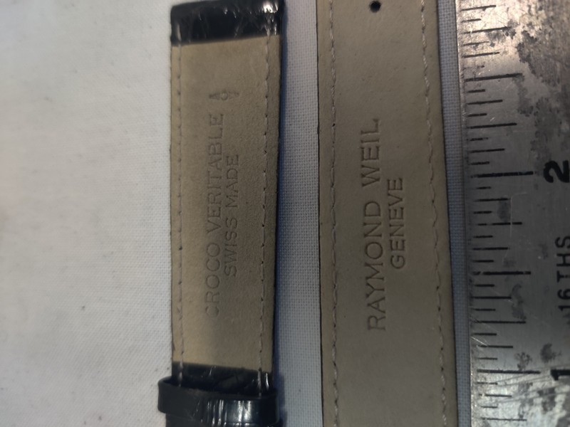 Raymond Weil watch strap is made of black leather and gold buckle.