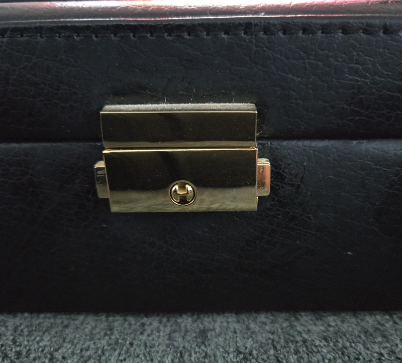 Rowallan watch box features a textured black exterior and a clear plastic window gallery