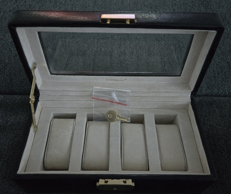 Rowallan watch box features a textured black exterior and a clear plastic window gallery